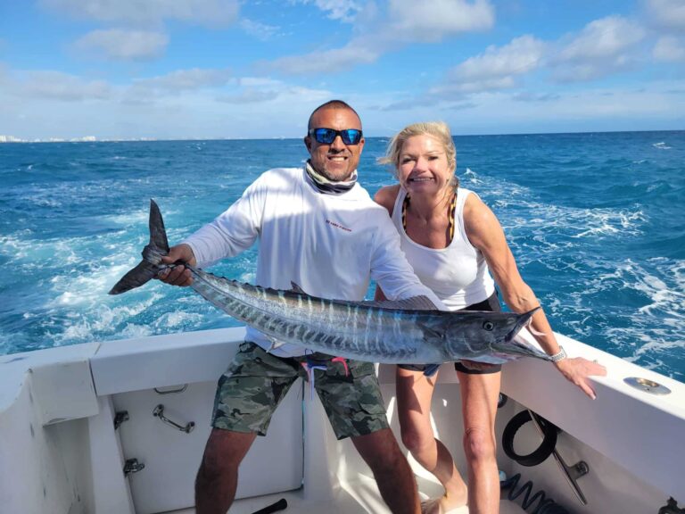 A female angler with a trophy wahoo catch.